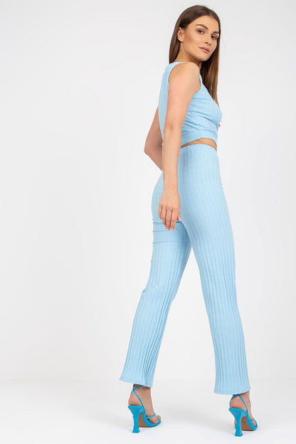 Italy Moda 2-Piece Ribbed Cotton Set displayed by a poised woman in a flattering light blue outfit, including a short top and high-waist long pants, exuding sophistication.