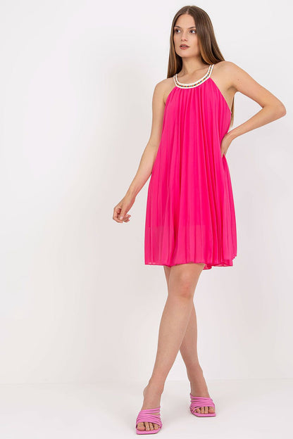 Model posing in the Elegant Summer Strapless Pleated Dress by Italy Moda in striking pink, enhanced with a decorative neckline, perfect for chic summer events.