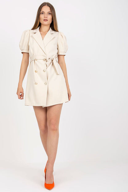 Elegant Italy Moda Envelope Dress with Short Sleeves and Tie Belt for Various Occasions, displayed on a model in a chic beige colour, featuring double-breasted buttons and a waist tie, complemented by bright orange heels.