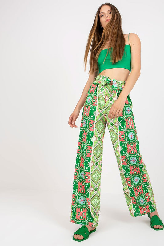 Italy Moda Women's High-Waisted Wide-Leg Trousers with Elastic Waistband - Elegant Comfort Pants in vibrant green with floral patterns, styled elegantly with a matching crop top, exuding luxury and comfort.