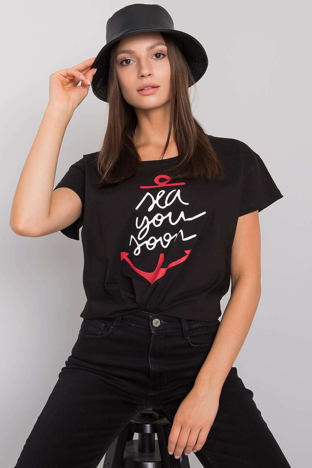Fancy Ladies' Short Sleeve Cotton T-Shirt with Decorative Print - Round Neck Style, model showcasing a stylish black t-shirt with a playful anchor print and the phrase 'sea you soon' while wearing a chic bucket hat.