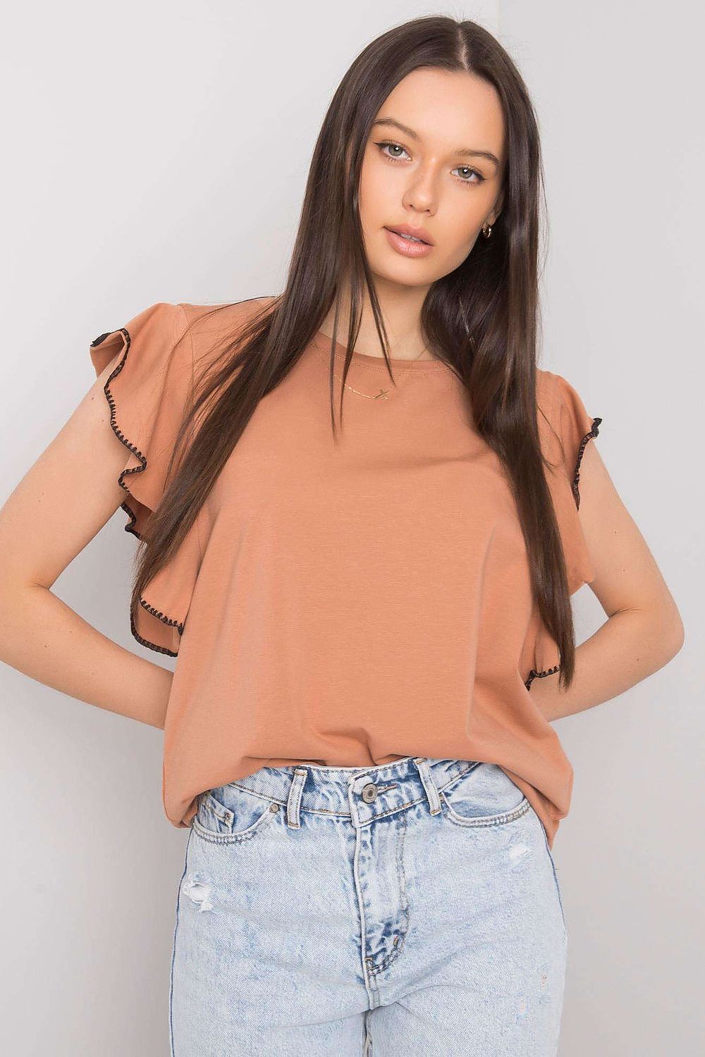 Elegant Frill Sleeve Cotton Blend Blouse with Round Neck – Versatile Everyday Wear, model presenting a brown frill sleeve blouse paired with distressed jeans.