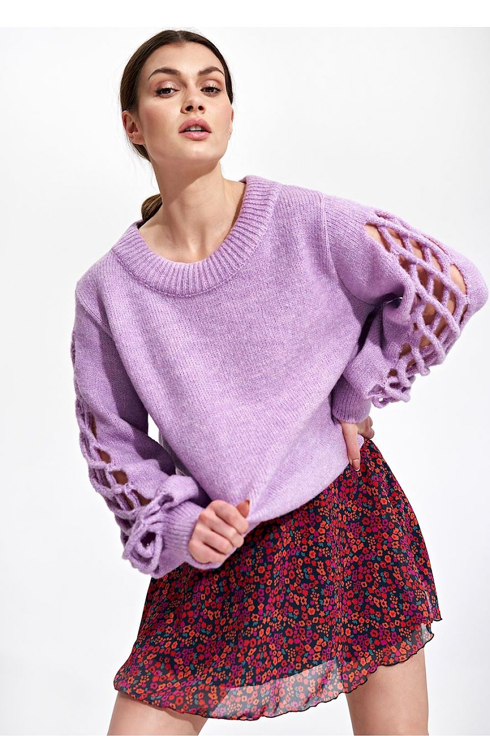 Close-up of model highlighting the Flared Mini Skirt by Figl, elegantly paired with a lavender sweater, radiating sophistication and femininity.