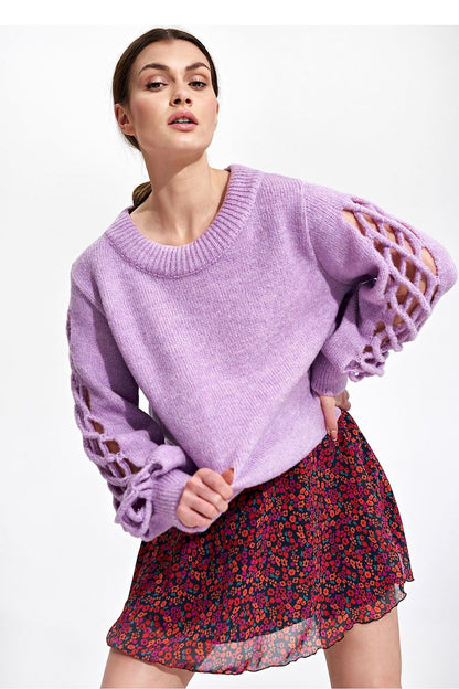Close-up of model highlighting the Flared Mini Skirt by Figl, elegantly paired with a lavender sweater, radiating sophistication and femininity.