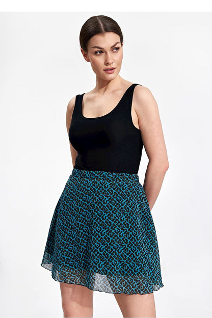 Sleek model presenting the Flared Mini Skirt by Figl in a bold geometric print, complemented by a classic black tank top for an elegant statement.