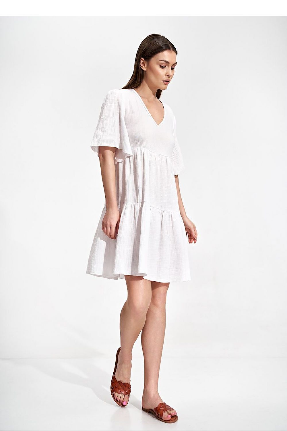 Elegant Summer Flared Mini Dress with Ruffles and Short Sleeves by Figl, showcasing a model in a white dress with a flared hem and short sleeves, perfect for warm weather occasions.