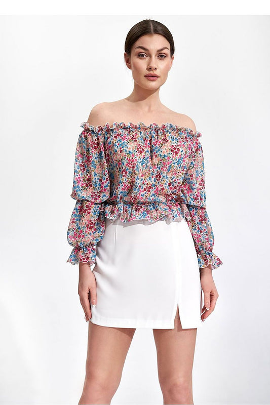 Elegantly Airy Figl Long Sleeve Blouse with Elastic Bands - Model showcases a floral off-shoulder blouse paired with a white skirt, exuding luxury and femininity.