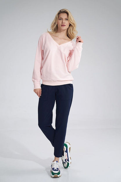 Model wearing Luxury Figl Cotton V-Neck Sweatshirt with Ribbed Hem and Decorative Ribbon paired with sporty shoes, exuding a chic, contemporary style.