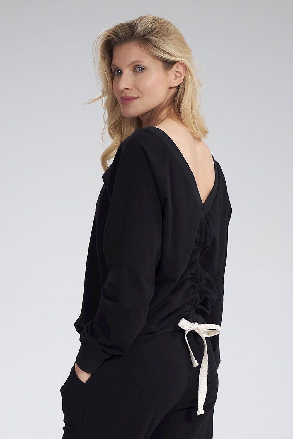 Luxury Figl V-Neck Cotton Blouse with Decorative Ribbon showcased from the back, featuring long sleeves and a ribbed hem, ideal for elegant styling.