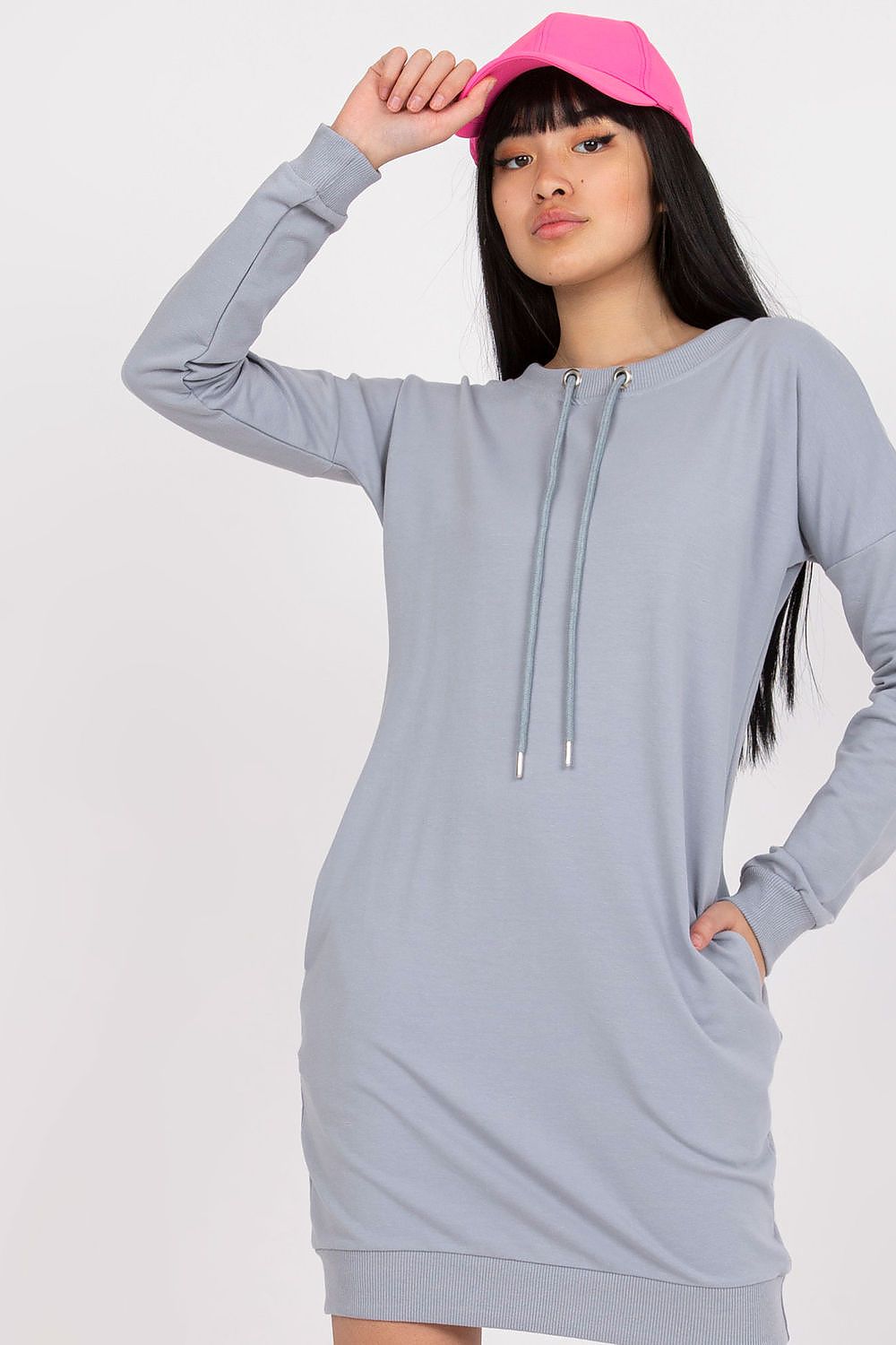 Elegant BFG Long Sleeve Sweatshirt Dress with Tieback Strap and Side Slip Pockets, showcased in light grey, modelled by a stylish woman wearing a pink cap.