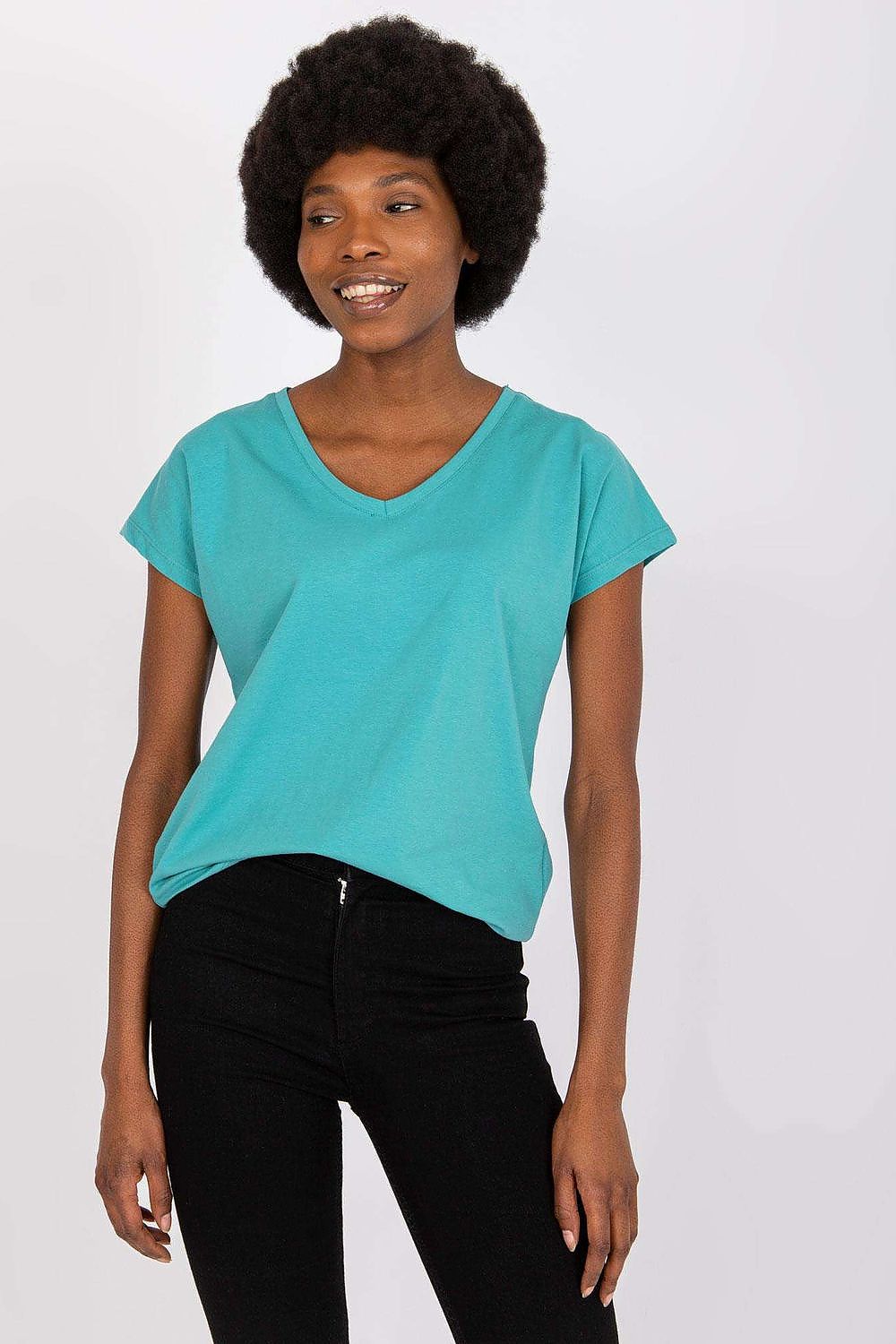 Luxury BFG Heart Neckline T-Shirt worn by a smiling model, elegantly paired with black jeans, highlighting the elegant cut and vibrant colour.