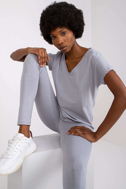 Model in a grey Luxury BFG Heart Neckline T-Shirt and leggings, posing elegantly against a white backdrop, perfect for luxury casual attire.
