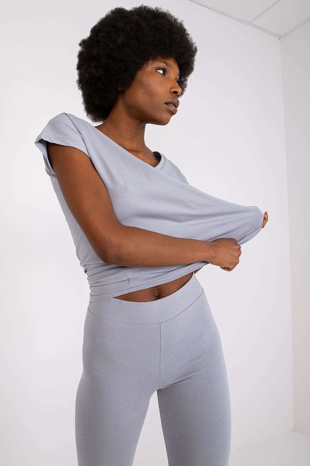Luxury BFG Heart Neckline T-Shirt in soft grey cotton blend, elegantly styled on a model with an afro hairstyle.
