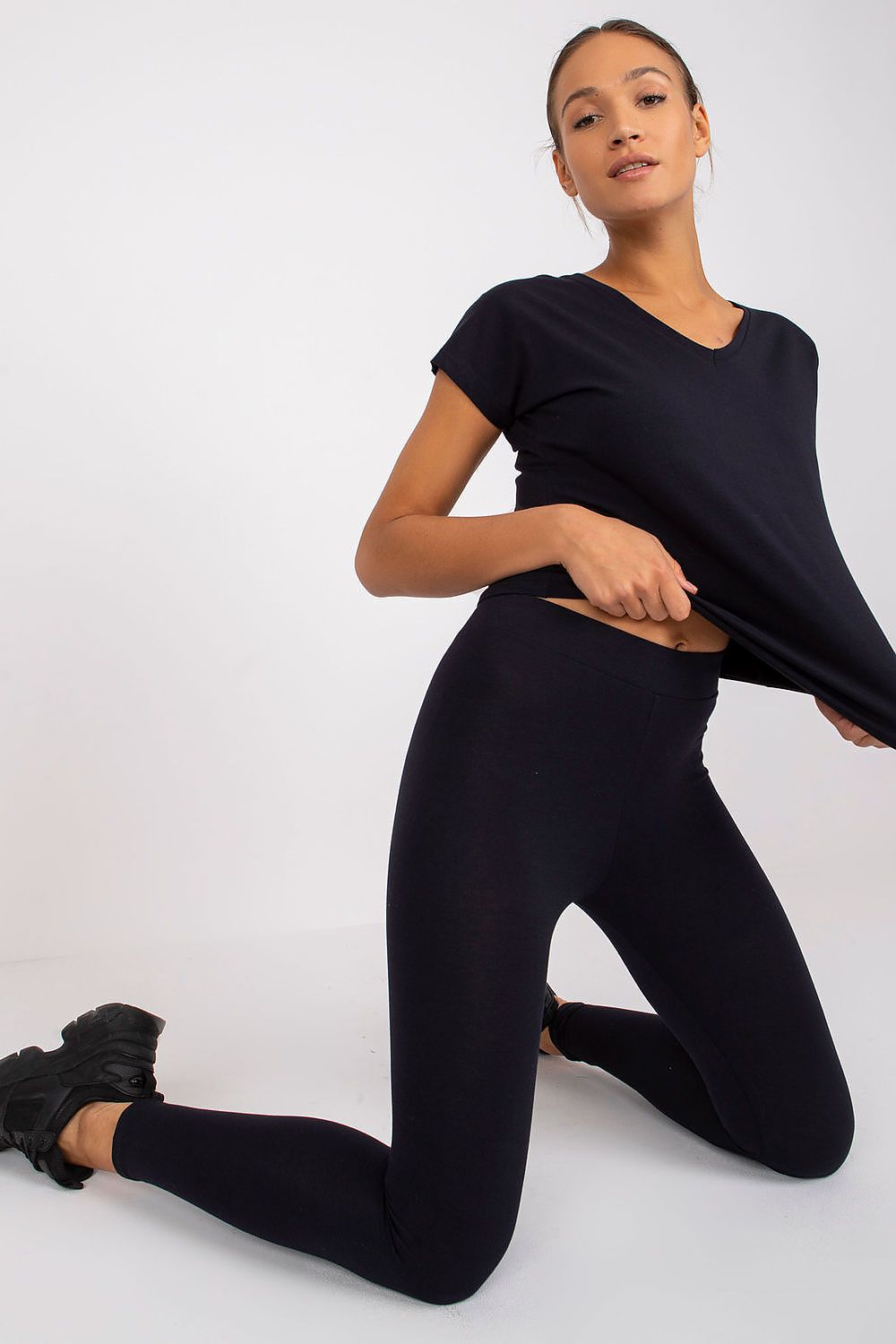 Luxury BFG Heart Neckline T-Shirt in black, worn by a model sitting in a stylish pose highlighting the elegant cut.