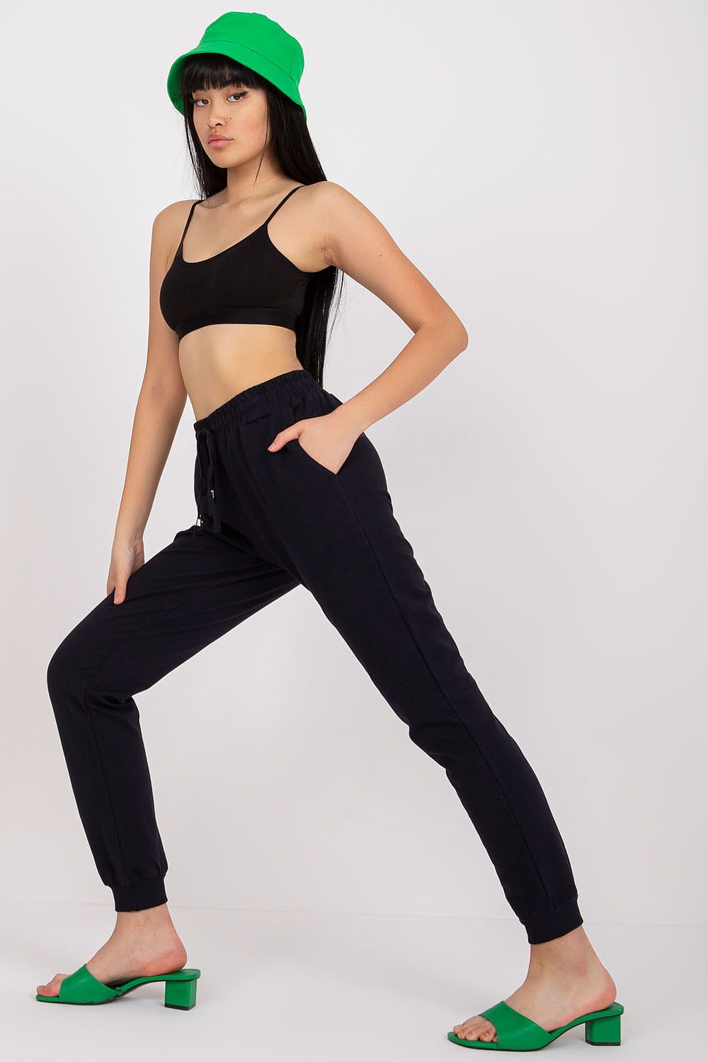 Model confidently posing in BFG High Rise Tracksuit Trousers with Drawstring Waist and Side Slash Pockets, capturing the essence of modern luxury in athleisure wear.