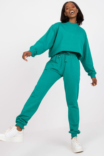 BFG High Rise Tracksuit Trousers with Drawstring Waist and Side Slash Pockets, model joyfully showcasing a vibrant turquoise look, perfect for a luxurious yet comfortable lifestyle.