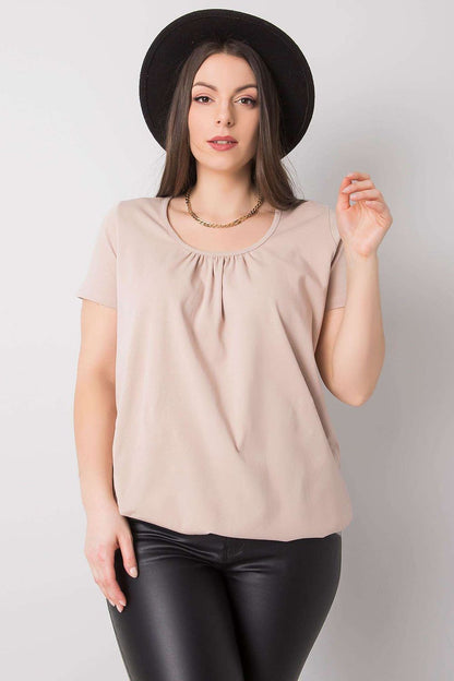 Elegant BFG Women's Plus Size T-Shirt in chic beige, highlighting a relaxed fit with a round neckline, paired with classy black leather pants, perfect for luxurious everyday wear. Sizes 2XL to 4XL.