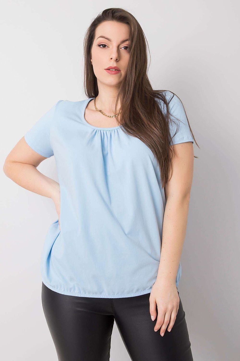 Sophisticated BFG Women's Plus Size T-Shirt in a refreshing light blue, designed with short sleeves and a flattering round neckline, styled with black leather trousers, ideal for a luxurious casual ensemble. Sizes 2XL to 4XL.