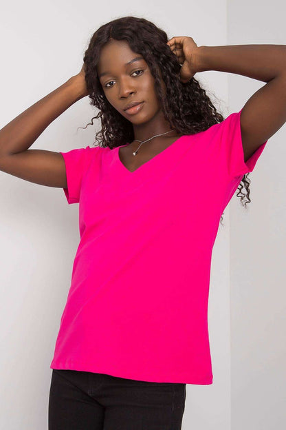 Elegant Short Sleeve Cotton Blouse With Heart Neckline And Deep Cutout model posing gracefully, highlighting the chic V-neck and flowing silhouette in a bright pink hue.