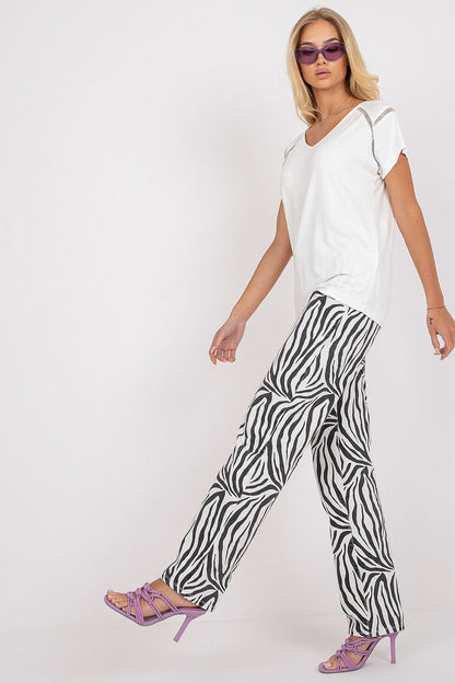 Elegant Short Sleeve Blouse with Heart Neckline elegantly worn by a model, pairing with zebra print pants and luxury heels, perfect for a trendy high-fashion ensemble.