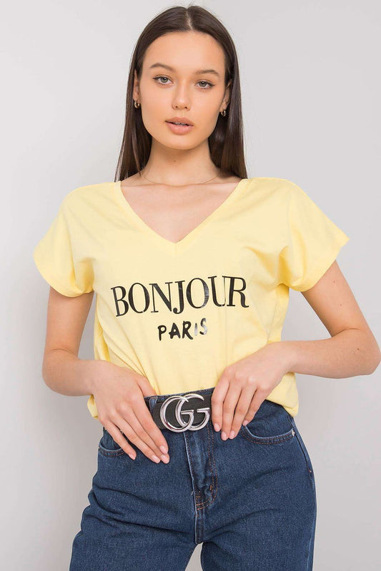 Luxury Cotton T-Shirt with Heart-Shaped Neckline and Decorative Inscription, featuring a lively yellow hue and stylish 'BONJOUR PARIS' print, worn by a model who pairs it with high-waisted denim jeans.