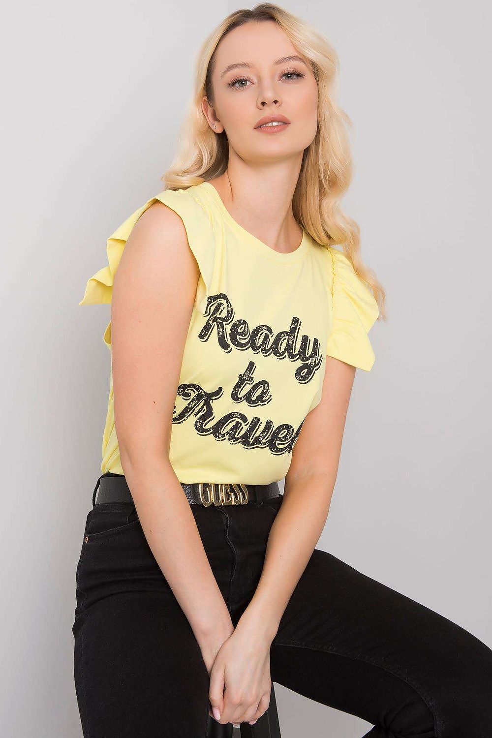 Chic view of the Elegant Short Sleeve Frill Blouse with Decorative Inscription, showcasing a relaxed fit and fashionable frill detailing in a vibrant yellow hue.
