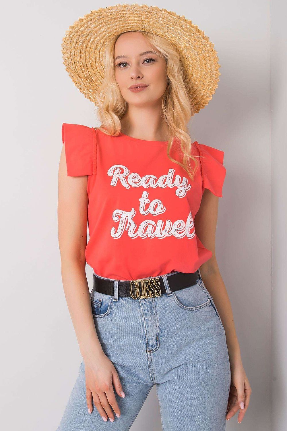 Elegant Short Sleeve Frill Blouse with Decorative Inscription - Cotton and Lycra Blend, showcasing a stunning model wearing a coral blouse with a decorative 'Ready to Travel' print, complemented by a stylish straw hat and high-waisted denim.