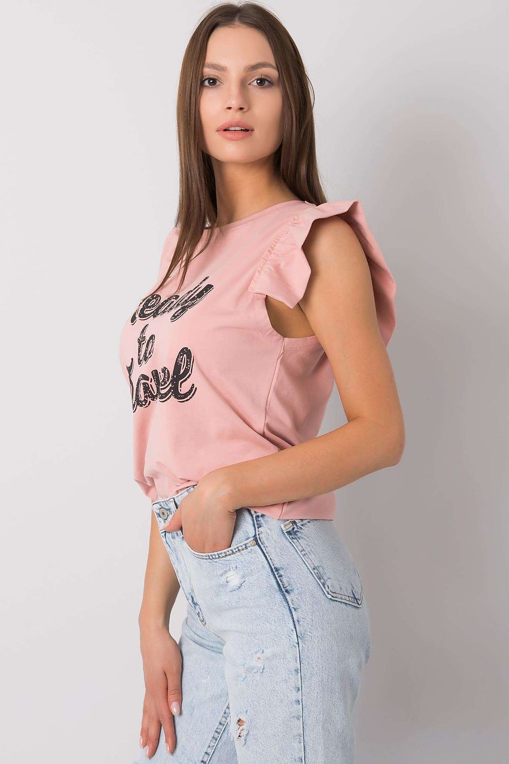 Elegant Short Sleeve Frill Blouse with Decorative Inscription - Cotton and Lycra Blend. Stylish model posing sideways in the blouse, emphasising the intricate frill detailing and casual chic aesthetic.