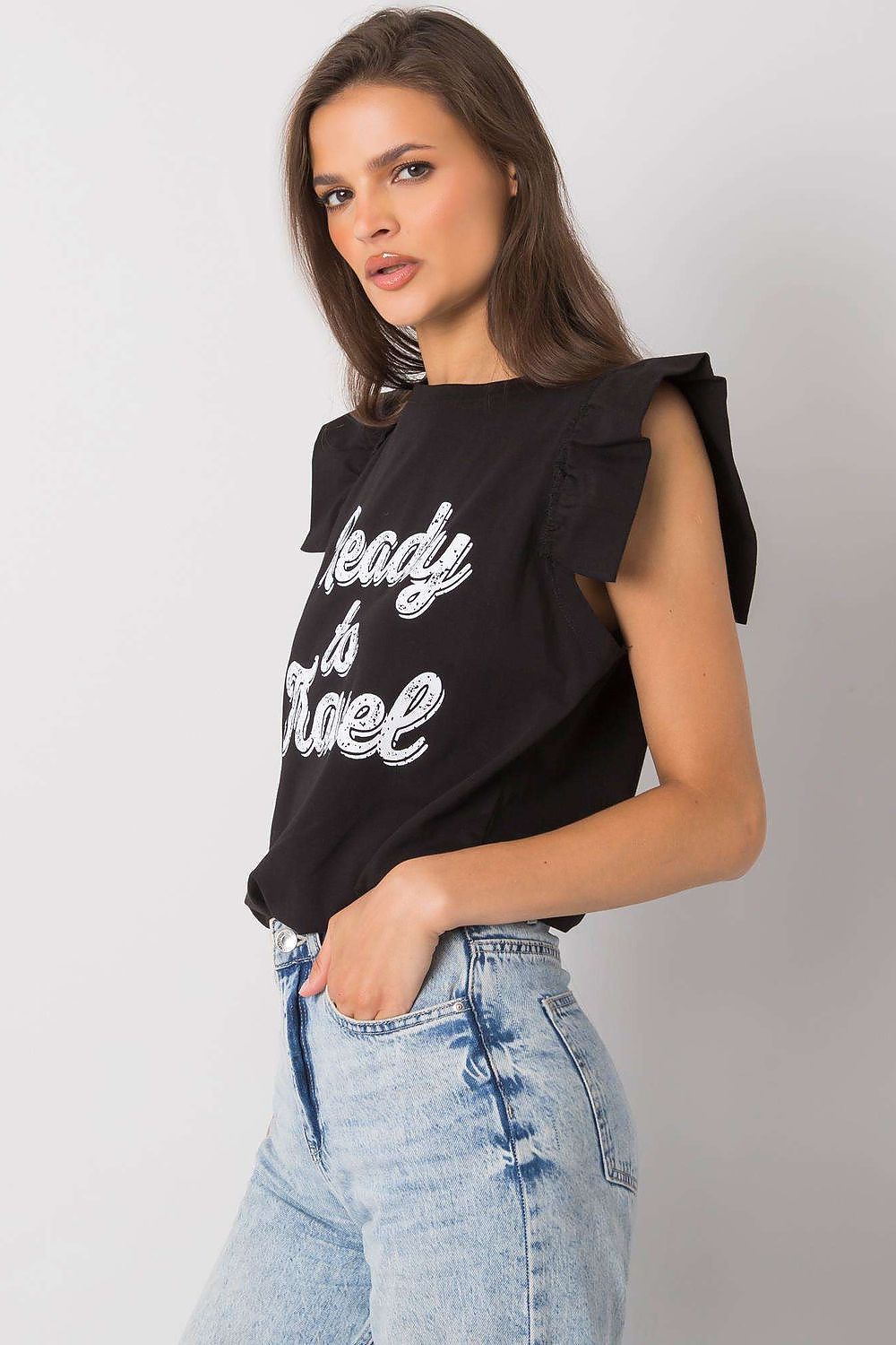 Elegant Short Sleeve Frill Blouse with Decorative Inscription - Cotton and Lycra Blend, model in profile showcasing the black frill sleeve blouse with 'Ready to Travel' print, paired with light denim.