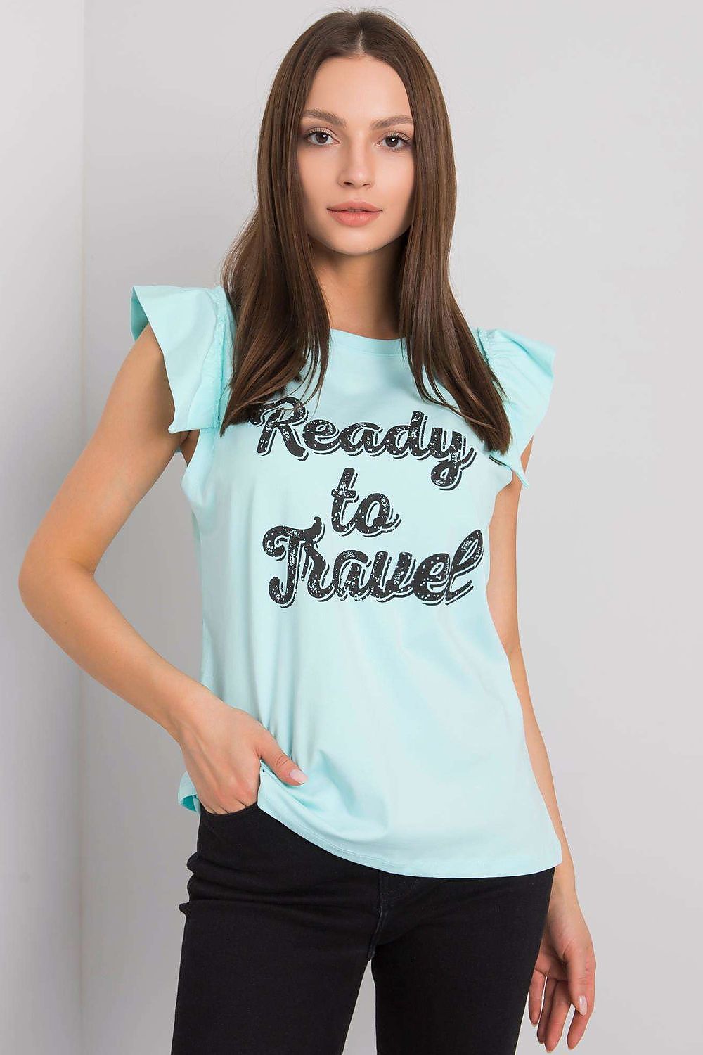 Elegant Short Sleeve Frill Blouse with Decorative Inscription - Cotton and Lycra Blend, model wearing a light blue blouse featuring frill sleeves and 'Ready to Travel' motif, styled with fitted trousers.