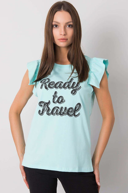 Elegant Short Sleeve Frill Blouse with Decorative Inscription - Cotton and Lycra Blend, front view of a model in a light blue frill blouse with 'Ready to Travel' inscription, complemented by stylish black pants.