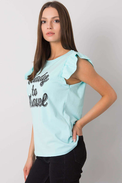 Elegant short sleeve frill blouse with decorative inscription, crafted from a luxurious cotton and Lycra blend, model showcasing the light aqua colour and fashionable inscription 'Ready to Travel' on a stylish figure, perfect for chic summer outings.
