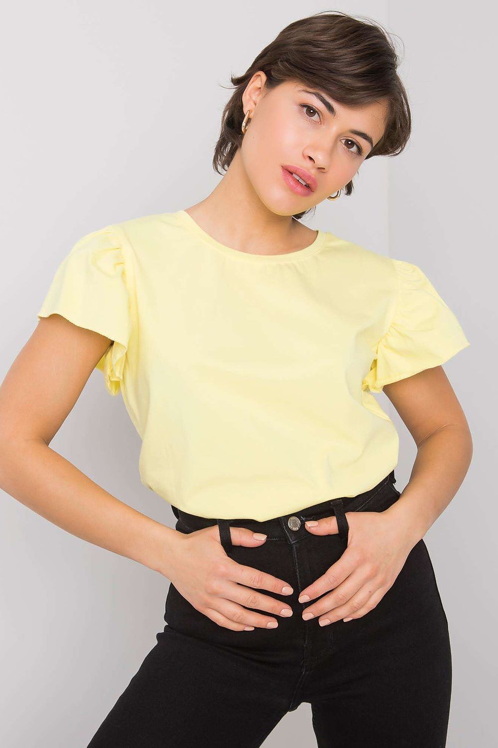 Elegant Cotton And Lycra Frill Sleeve Blouse With Round Neckline in yellow, elegantly styled with high-waisted black jeans, perfect for any occasion.