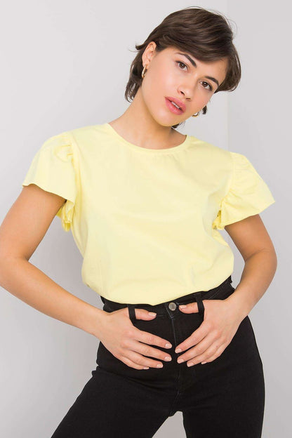 Elegant Cotton And Lycra Frill Sleeve Blouse With Round Neckline in yellow, elegantly styled with high-waisted black jeans, perfect for any occasion.