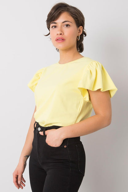 Elegant Cotton And Lycra Frill Sleeve Blouse With Round Neckline, displayed in a stunning yellow colour, paired seamlessly with chic black jeans for versatile styling.