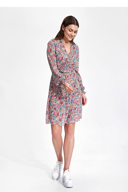 Elegant Figl Summer Mini Dress with Long Sleeves, Ruffle Hem, and Waist Detail - Model smiling while wearing the fashionable floral mini dress, perfect for summer outings.