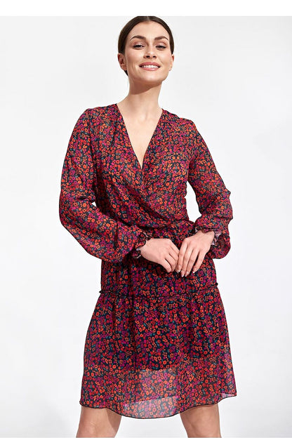 Elegant Figl Summer Mini Dress with Long Sleeves, Ruffle Hem, and Waist Detail, featuring a model smiling and posing with vibrant floral patterns in a luxurious fabric.