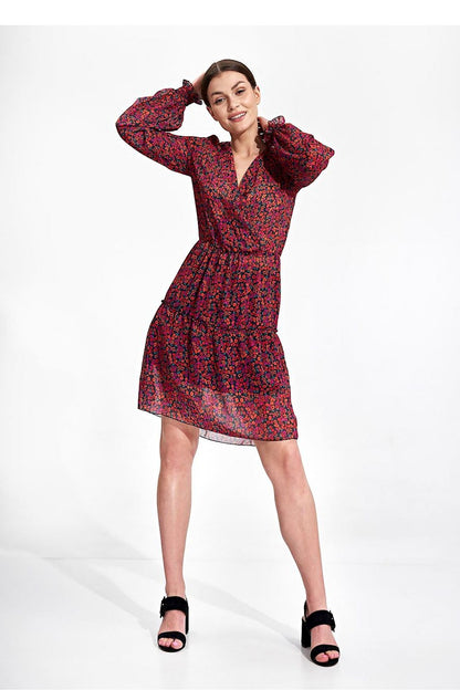 Elegant Figl Summer Mini Dress with Long Sleeves, Ruffle Hem, and Waist Detail, featuring a cheerful model with hands raised in a playful pose, accentuating the dress’s elegant flow.