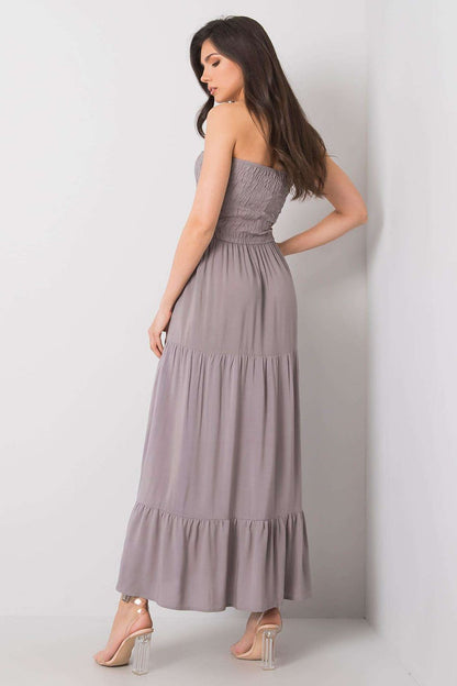 Back view of a chic strapless long summer dress in a sophisticated grey tone, featuring an elegant ruffle hem and crafted from 100% viscose by Fresh Made.