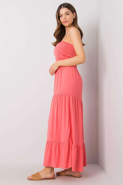 Elegant Strapless Long Summer Dress with Ruffle Hem – 100% Viscose by Fresh Made, model seen from the side, highlighting the flattering silhouette and lightweight fabric of the stylish coral dress with ruffle detailing.