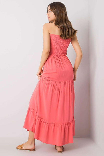 Elegant Strapless Long Summer Dress with Ruffle Hem – 100% Viscose by Fresh Made, model displaying the back view of the gorgeous coral dress, showcasing the smocked top and graceful ruffle hem, perfect for summer events.