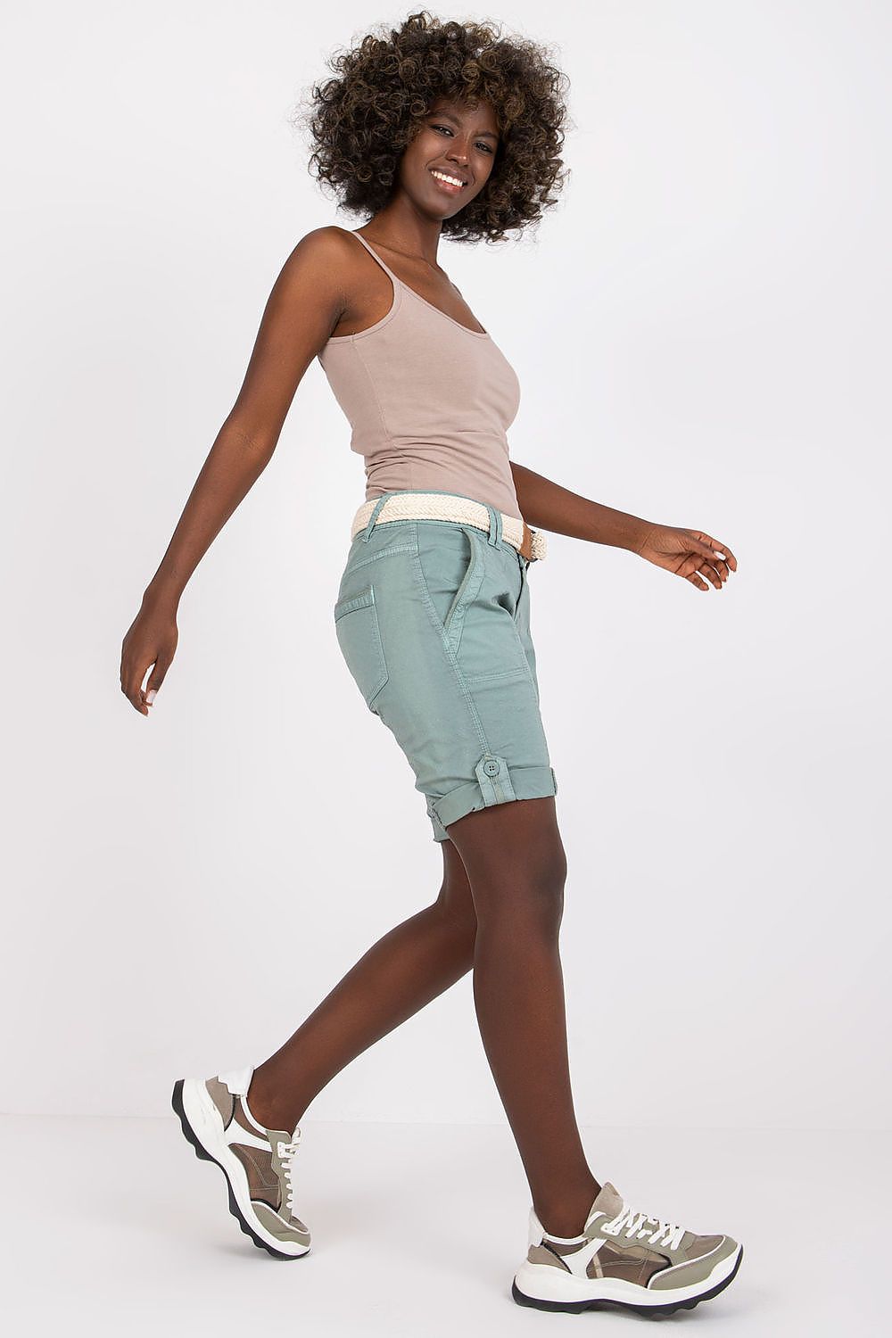 Chic representation of Stitch&Soul zippered cotton shorts with braided belt, worn stylishly while walking, epitomising effortless summer elegance.