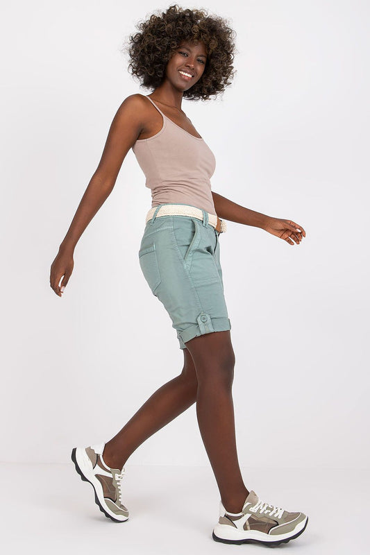 Chic representation of Stitch&Soul zippered cotton shorts with braided belt, worn stylishly while walking, epitomising effortless summer elegance.