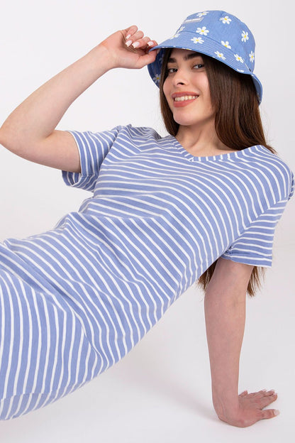 Discover luxury in leisure with the Stitch&Soul Summer Striped Cotton Daydress, modelled by a woman in a relaxed position, radiating summer vibes and casual sophistication.