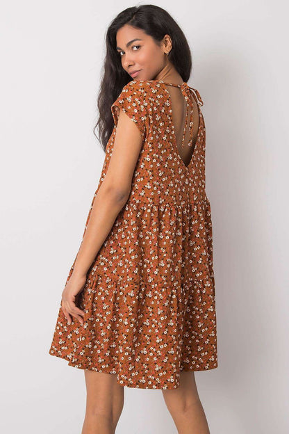 Elegant loose-fitting daydress by Stitch&Soul featuring a chic back tie detail, providing a stylish look with a delicate floral design, perfect for luxury casual wear.