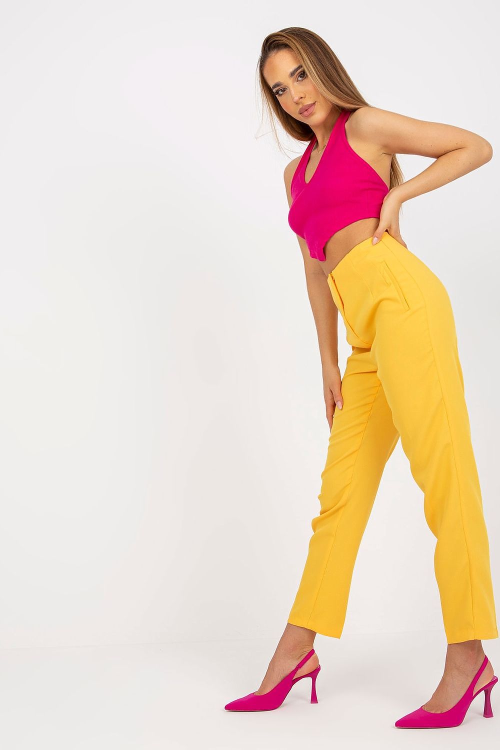 Fashion-forward image of a woman in Xsapienza Women’s High-Waisted Straight Cut Trousers, showcasing a chic ensemble with a pink top and heels, perfect for a stylish look.