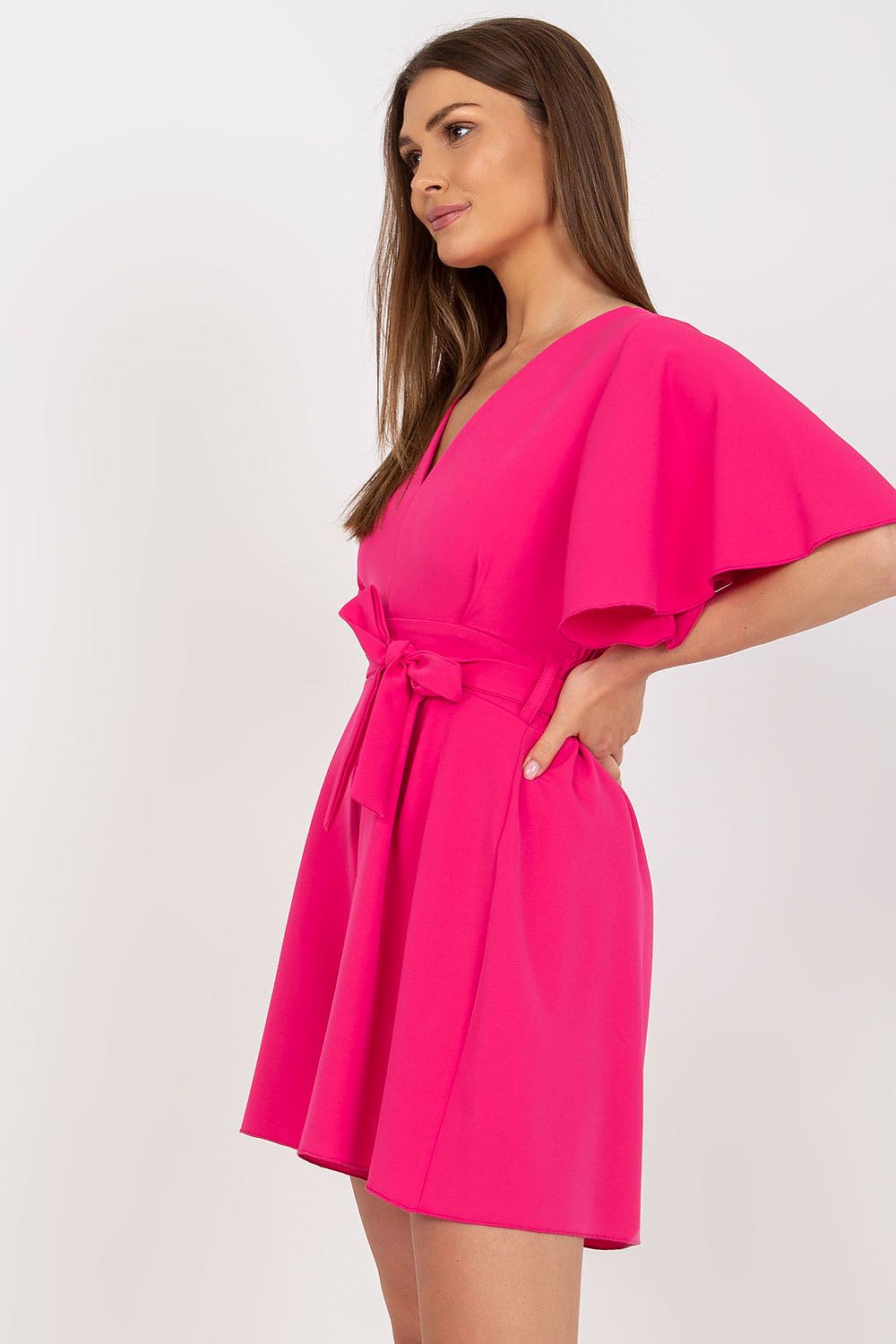 Elegant Rue Paris jumpsuit with cheeky neckline and tied waist, showcased in vibrant pink, designed for sophistication and style – perfect for any occasion.