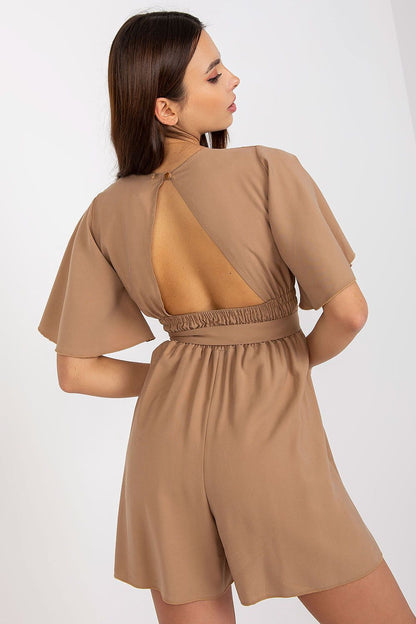 Elegant Rue Paris jumpsuit with cheeky neckline and tied waist, presenting a stylish back view in soft beige, perfect for exuding elegance on any occasion.