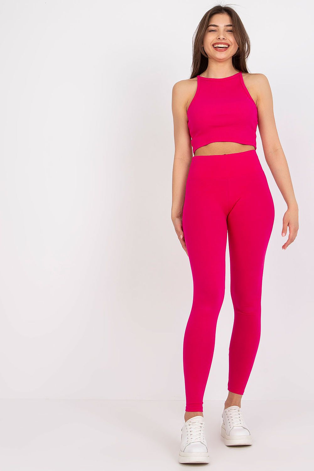 Model exuding effortless elegance in Rue Paris Luxury Sports Leggings with Wide Elastic Waistband, paired with a pink crop top and sporty white sneakers, perfect for a chic workout look.