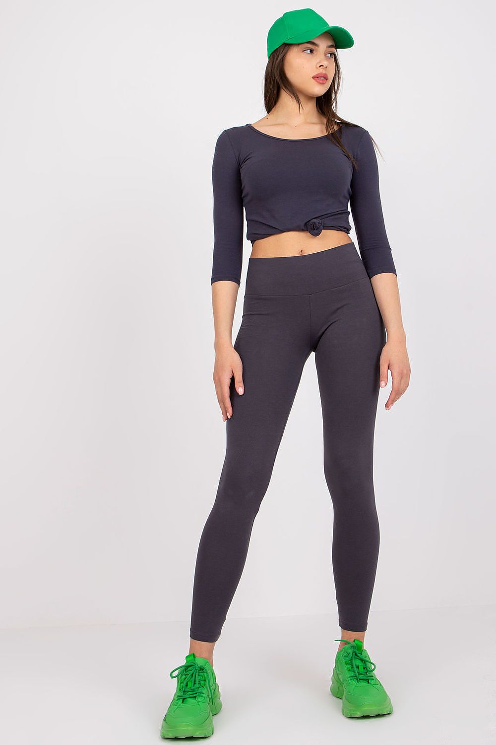 Rue Paris Luxury Sports Leggings with Wide Elastic Waistband, elegant grey leggings complemented by a teal cap and green trainers, perfect for a chic athletic look.